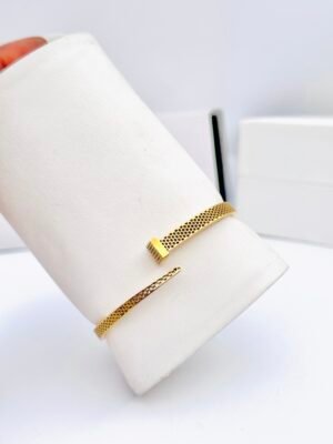 "Stainless steel tarnish-free gold bangle with sleek, minimalist design for women