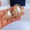 Sunburst pearl earrings with central pearl and radiant gold design for women